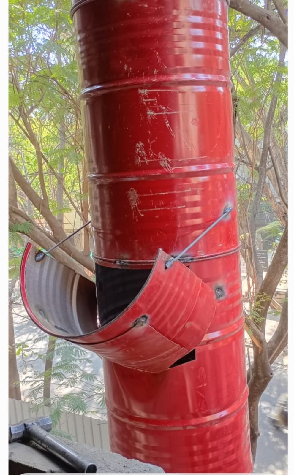 Close-up of a red debris chute inlet used for safe waste disposal during building work in Pune