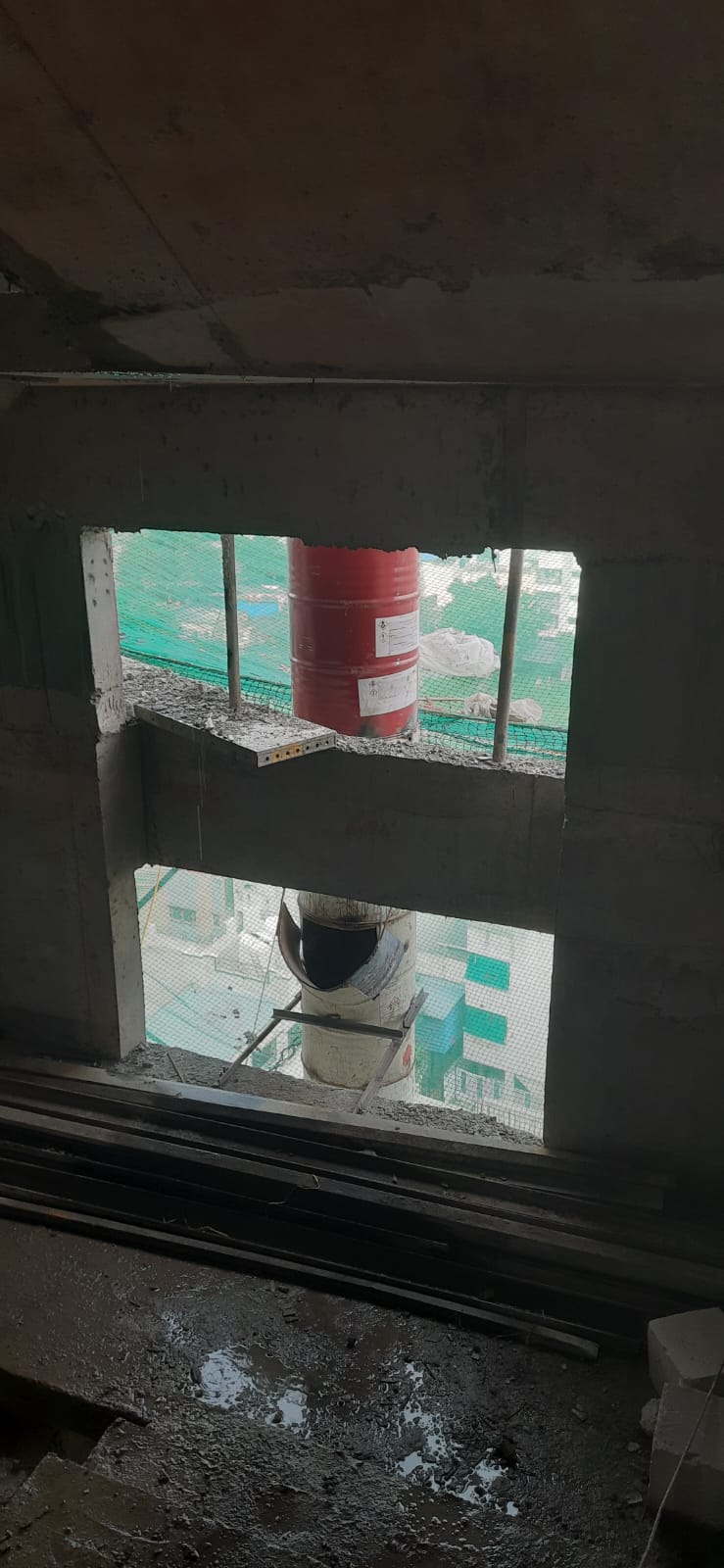 Debris chute passing through slab openings between floors of a building in Pune